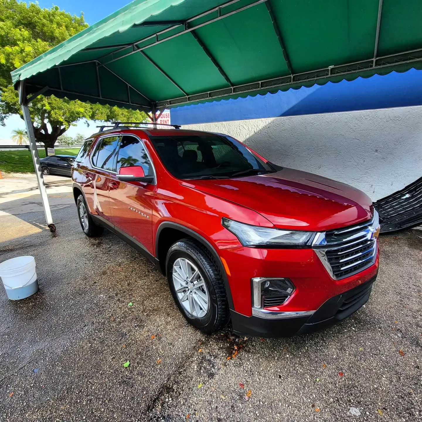 Red Chevrolet Traverse SUV freshly detailed at Marlin Motors in Cutler Bay, FL
